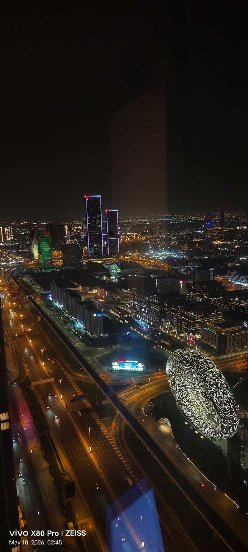 Aerial night view of the Dubai skyline and highways from a high-rise